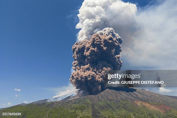 Smoke rises from the crater of the Etna volcano as it erupts, on Mount Etna near Catania on June 2, 2025. A huge plume of ash, gas and rock spewed...