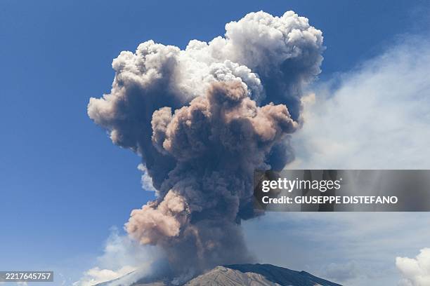 Smoke rises from the crater of the Etna volcano as it erupts, on Mount Etna near Catania on June 2, 2025. A huge plume of ash, gas and rock spewed...