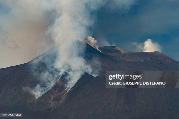Smoke rises from the crater of the Etna volcano as it erupts, on Mount Etna near Catania on June 2, 2025. A huge plume of ash, gas and rock spewed...