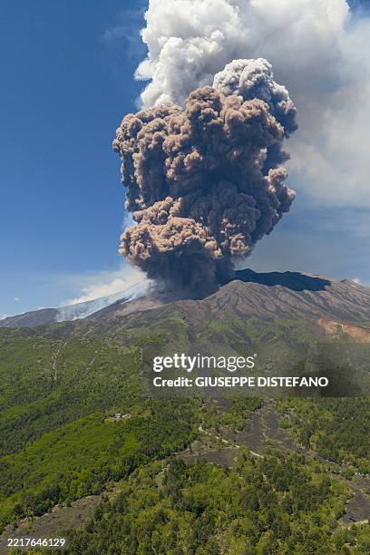 Smoke rises from the crater of the Etna volcano as it erupts, on Mount Etna near Catania on June 2, 2025. A huge plume of ash, gas and rock spewed...
