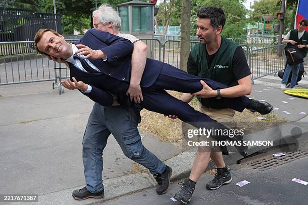 Greenpeace environmental activists set up a wax statue of French President Emmanuel Macron - they say to have stolen from the Musee Grevin - during...