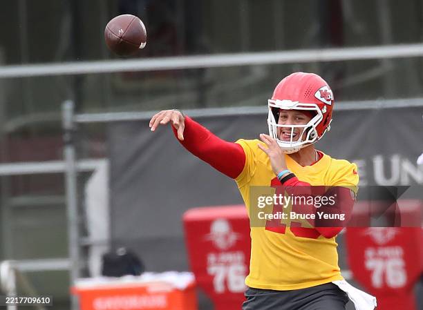 Quarterback Patrick Mahomes of the Kansas City Chiefs throws a pass to his coach during the Kansas City Chiefs OTAs at The University of Kansas...