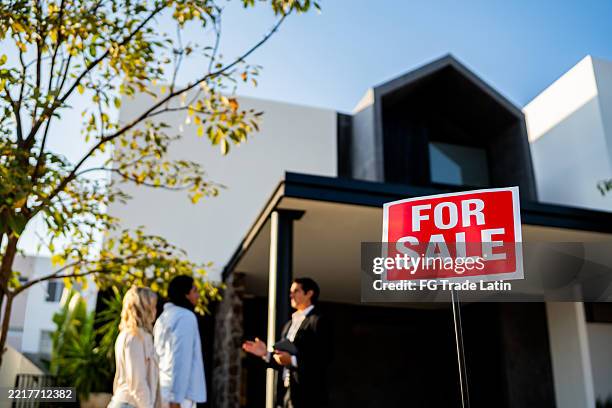 house with for sale sign in front yard - estate agent sign stock pictures, royalty-free photos & images