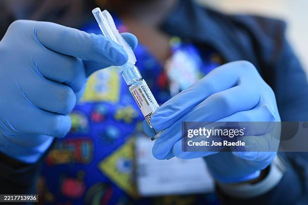 In this photo illustration, Ruth Jones, Immunization Nurse, holds a Pfizer-BioNTech COVID-19 vaccine at Borinquen Health Care Center on May 29, 2025...