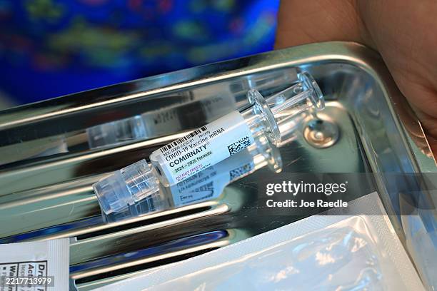 In this photo illustration, Ruth Jones, Immunization Nurse, carries a tray with a Pfizer-BioNTech COVID-19 vaccine at Borinquen Health Care Center on...