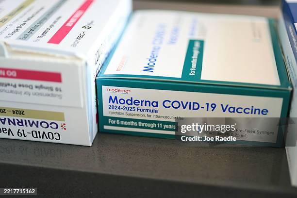 In this photo illustration, Pfizer-BioNTech COVID-19 and Moderna COVID-19 vaccines sit in boxes at Borinquen Health Care Center on May 29, 2025 in...
