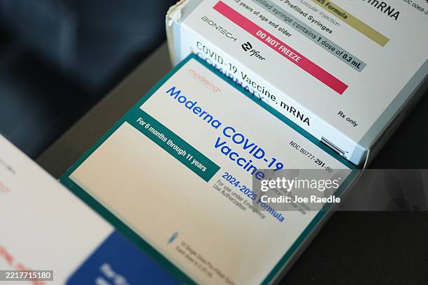 In this photo illustration, Pfizer-BioNTech COVID-19 and Moderna COVID-19 vaccines sit in boxes at Borinquen Health Care Center on May 29, 2025 in...