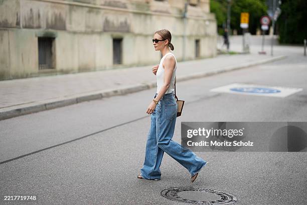 Marlies Pia Pfeifhofer is seen wearing a white ribbed racerback Isabel tanktop with high neckline and cutaway armholes from Citizens of Humanity, a...