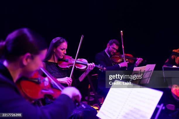 string quartet concert. two violins, viola and violoncello. talented musicians play instruments, creating graceful art on stage - classical musician stock pictures, royalty-free photos & images