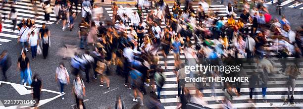 people walking in shibuya during rush hour in tokyo, japan - pedestrian zone stock pictures, royalty-free photos & images