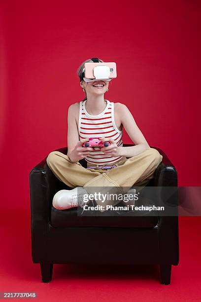 young woman enjoying virtual reality gaming with vr glasses headset - sudbury canada stock pictures, royalty-free photos & images