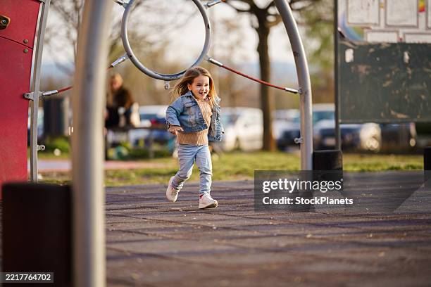 girl running at the playground - jean petit stock pictures, royalty-free photos & images