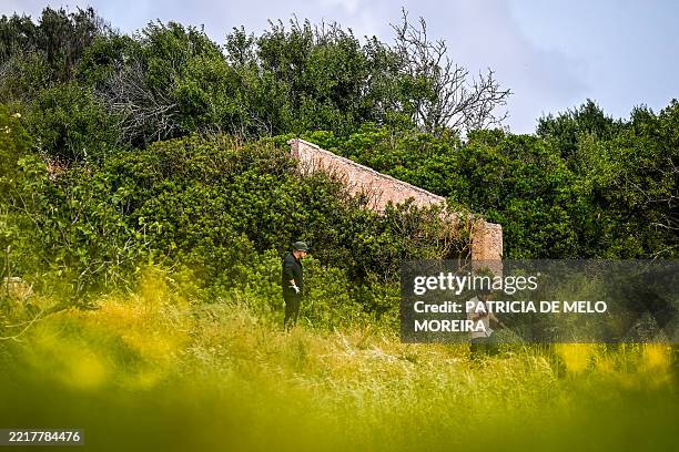 Criminal Investigators stand in a field near ruins during new search operations amid the investigation into the disappearance of Madeleine McCann at...