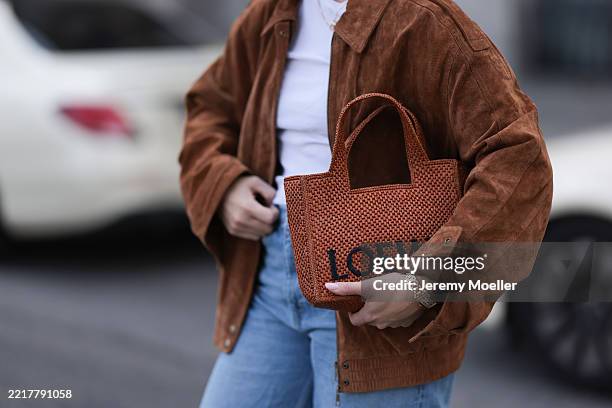 Sonia Lyson is seen wearing a fine gold necklace with round pendant; an oversized brown suede jacket from Zara; a white top from H&M underneath; a...