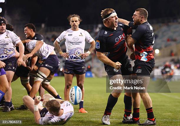 George Bell of the Crusaders celebrates with team mates after scoring a try during the round 16 Super Rugby Pacific match between the ACT Brumbies...