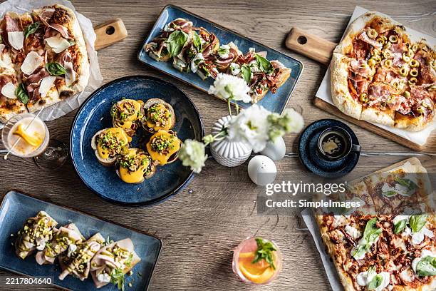 top view of various food, pizza, focaccia, toast breads or drinks on a table in a restaurant - spiral ham stock pictures, royalty-free photos & images