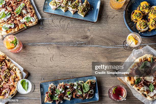 top view of various food, pizza, focaccia, toast breads or drinks on a table in a restaurant - spiral ham stock pictures, royalty-free photos & images
