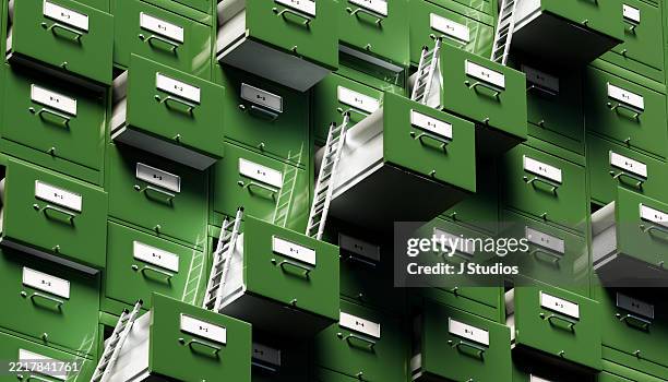grid of green filing cabinets with open drawers connected by ladders symbolizing data organization and climbing the corporate ladder - burocrazia foto e immagini stock