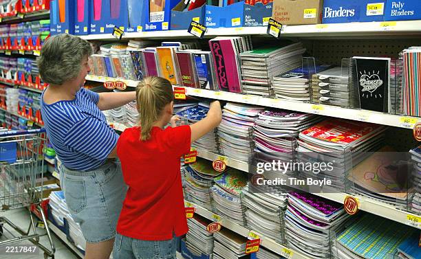 Shoppers peruse notebooks and other back-to-school items in a Wal-Mart store July 28, 2003 in Rolling Meadows, Illinois. Wal-Mart said that sales in...