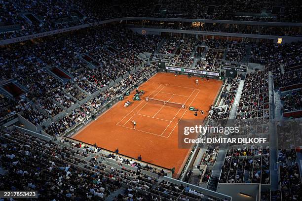 Spain's Carlos Alcaraz serves to US Tommy Paul during their quarter-final men's singles match on day 10 of the French Open tennis tournament on Court...