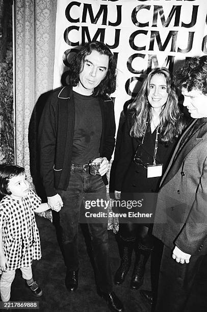 American New Wave & World musician David Byrne holds the hand of his daughter, Malu Abeni Valentine Byrne, as he poses with CMJ executive vice...