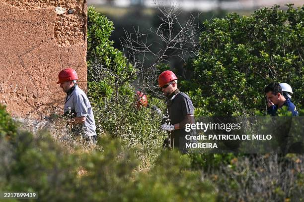 Police investigators work near an abandoned house during new search operations amid the investigation into the disappearance of Madeleine McCann at...