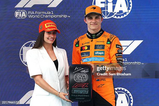 Marta Garcia presents Pole position qualifier Oscar Piastri of Australia and McLaren with his Pirelli Pole Position award during qualifying ahead of...