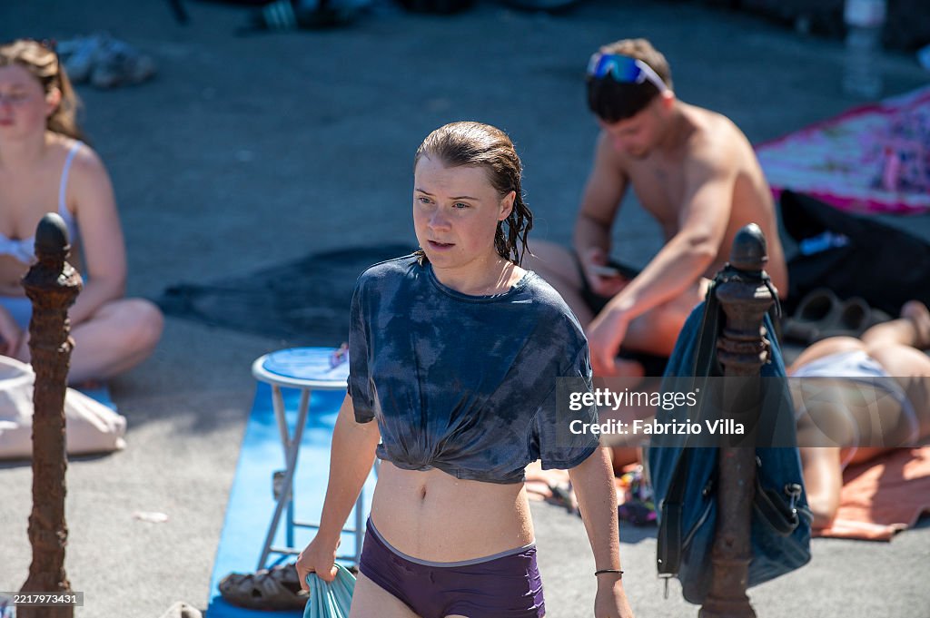 Greta Thunberg With A Thoughtful And Focused Expression Moves Among greta-thunberg-with-a-thoughtful-and-focused-expression-moves-among