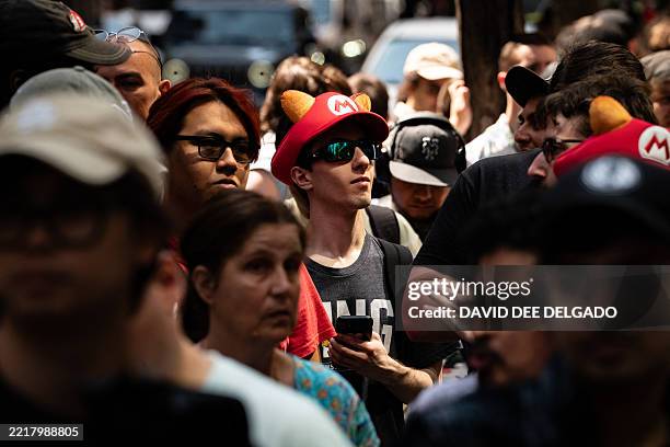 People wait in line ahead of the midnight release of the Nintendo Switch 2 at the Nintendo New York store on June 4, 2025. Nintendo hopes to match...