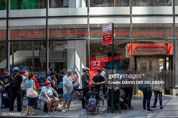 People wait in line at the Nintendo New York store on June 4 ahead of the midnight release of the Nintendo Switch 2. Nintendo hopes to match the...