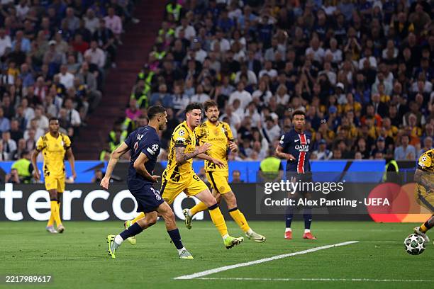 Achraf Hakimi of Paris Saint-Germain scores his team's first goal during the UEFA Champions League Final 2025 between Paris Saint-Germain and FC...