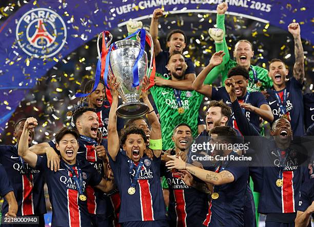 Marquinhos of Paris Saint-Germain lifts the UEFA Champions League trophy after his team's victory, to secure Paris Saint-Germain's first ever UEFA...
