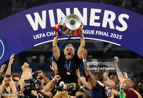 Luis Enrique, Head Coach of Paris Saint-Germain, lifts the UEFA Champions League trophy after his team's victory, to secure Paris Saint-Germain's...