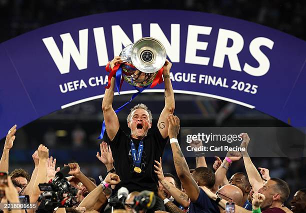 Luis Enrique, Head Coach of Paris Saint-Germain, lifts the UEFA Champions League trophy after his team's victory, to secure Paris Saint-Germain's...