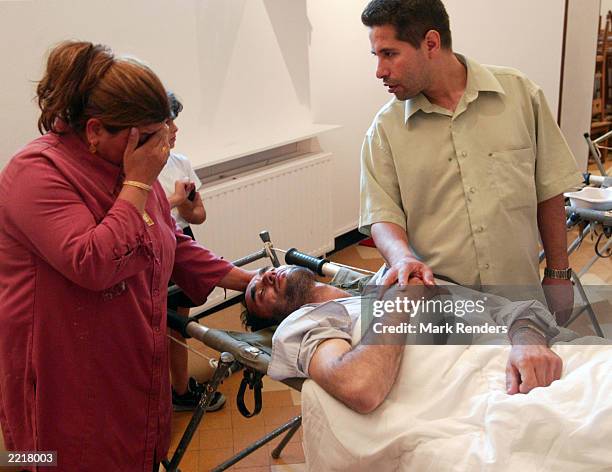 An Afghan refugee on hunger strike is visited by a relative at the Ixelles Sainte Croix July 28, 2003 in Brussels, Belgium. About 300 Afghan refugees...