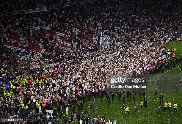 General view as fans of Paris Saint-Germain invade the pitch during the trophy celebrations after their team's victory, to secure Paris...
