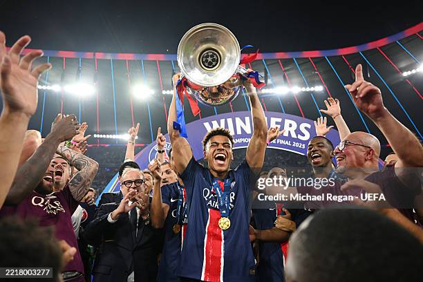 Desire Doue of Paris Saint-Germain lifts the UEFA Champions League trophy after his team's victory, to secure Paris Saint-Germain's first ever UEFA...