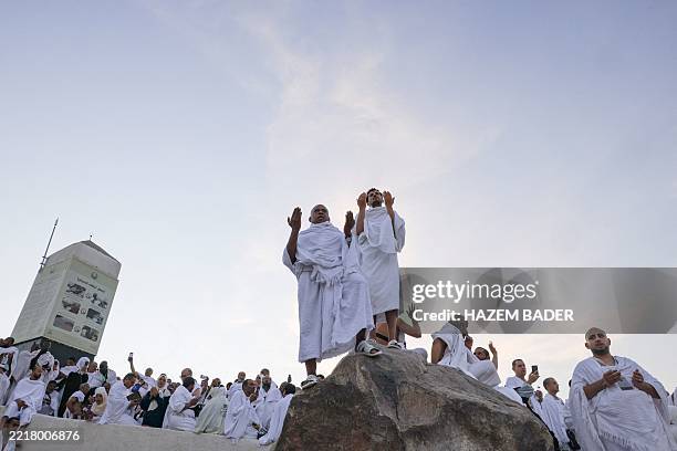 Muslim pilgrims pray at dawn on Saudi Arabia's Mount Arafat, also known as Jabal al-Rahma or Mount of Mercy, during the climax of the Hajj pilgrimage...