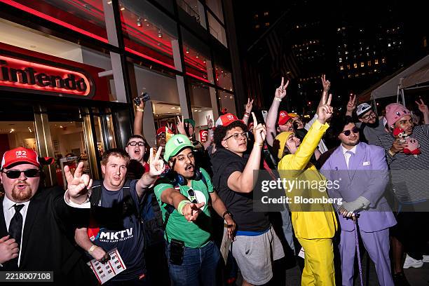 Customers react as they wait in line outside a Nintendo store ahead of the Nintendo Switch 2 game console release in New York, US, on Wednesday, June...
