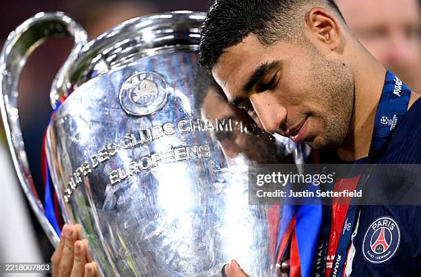 Achraf Hakimi of Paris Saint-Germain celebrates with the UEFA Champions League trophy after his team's victory, to secure Paris Saint-Germain's first...