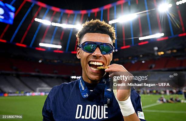 Desire Doue of Paris Saint-Germain bites his Winners Medal after his team's victory, to secure Paris Saint-Germain's first ever UEFA Champions League...