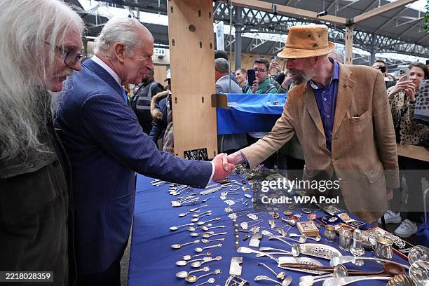 LONDON, ENGLAND King Charles III greets a stall holder as he tours Old Spitalfields Market and visits South By Southwest London on June 5, 2025 in...