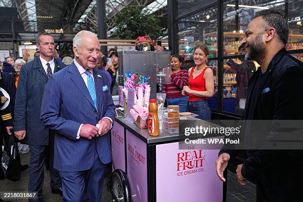 LONDON, ENGLAND King Charles III meets stall holders as he tours Old Spitalfields Market and visits South By Southwest London on June 5, 2025 in...