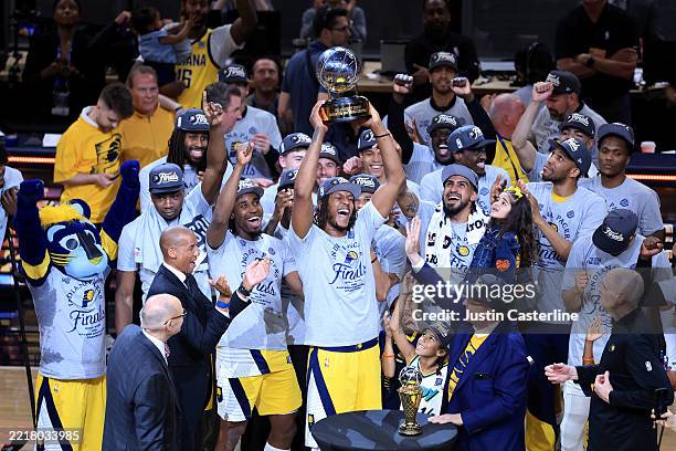 Myles Turner of the Indiana Pacers celebrates with the Bob Cousy Trophy after the 125-108 win against the New York Knicks in Game Six of the Eastern...