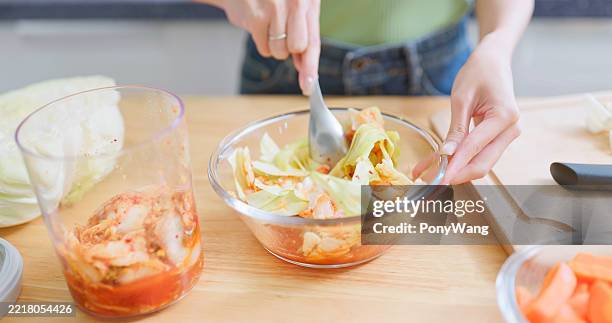 asian woman making kimchi - i was turning into a vegetable stock pictures, royalty-free photos & images
