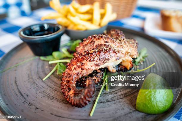 grilled octopus with arugula lime and french fries greece - octopus stock pictures, royalty-free photos & images