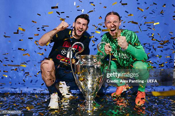 Khvicha Kvaratskhelia and Matvey Safonov of Paris Saint-Germain pose for a photo with the UEFA Champions League Trophy during the official UEFA...