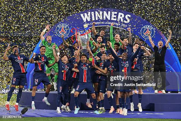 Marquinhos of Paris Saint-Germain lifts the UEFA Champions League trophy after his team's victory, to secure Paris Saint-Germain's first ever UEFA...