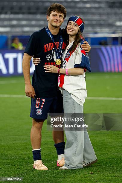 Joao Neves of PSG and his girlfriend Madalena Aragao celebrate following the UEFA Champions League Final 2025 between Paris Saint-Germain and FC...