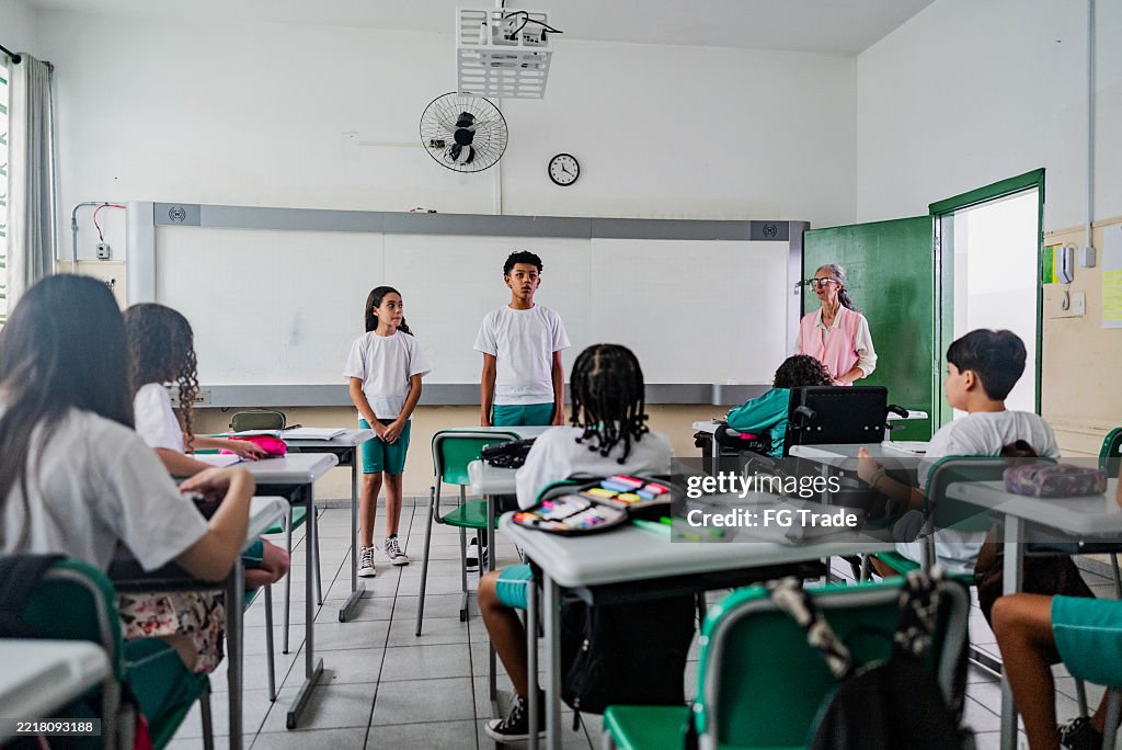 Elementary students speaking in front of class